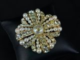 a close up of a ring with pearls on a pillow
