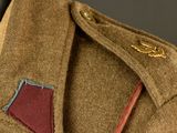 a close up of a military jacket with a red patch on it