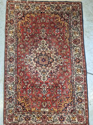a red rug with a medallion design on the middle of it
