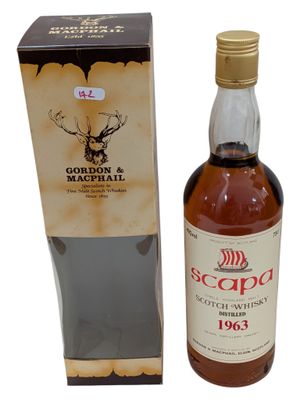 a bottle of scotch whisky in front of a cardboard box