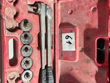 a red case with tools inside of it on a table