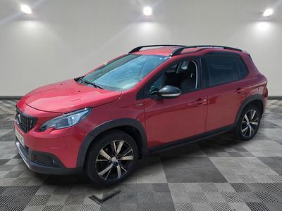 a red car parked in a room with a checkered floor