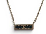 a close up of a necklace on a chain on a white background