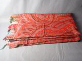 a close up of a red and orange scarf on a white background