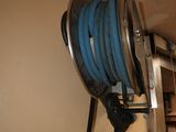 a blue hose attached to a wall in a room