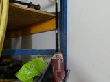 a picture of a room with a shelf and a hose on it