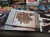 a lot of comic books on the table