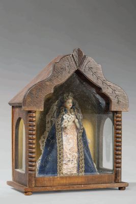 une image représentant un petit sanctuaire en bois abritant la statue d'une femme vêtue d'une robe bleue