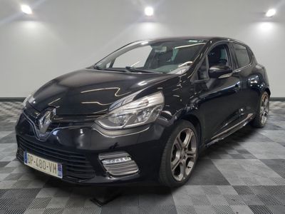 the black car is parked on a checkered floor in the garage