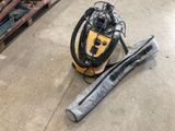 a vacuum that is sitting on the floor next to a bag