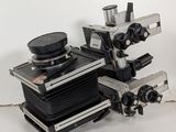 two cameras sitting on top of each other on a table