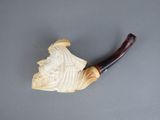 an old pipe sitting on top of a table next to a piece of wood