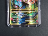 a close up of a pokemon card in a plastic case