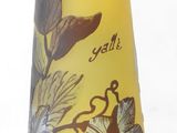 a yellow vase with a floral design on it