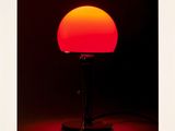 alternate view of a red lamp in the dark with a black background