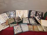a lot of stamps and folders sitting on a table