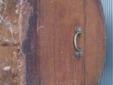 an old suitcase hanging on a wall outside