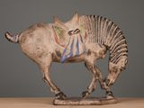 a figurine of a horse with a saddle on it