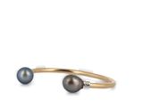 a close up of a black pearl and diamond cuff bracelet