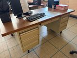 a computer desk with a keyboard and a monitor on it