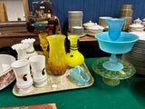 a lot of glass vases and bowls on the table
