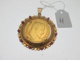 a close up of a gold coin on a white surface with a price tag