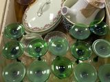a box full of green glass items on a table