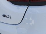the rear end of a white car with the word p p painted on it