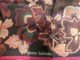 a close up of a scarf with flowers on it