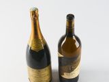 two bottles of wine sitting next to each other on a table