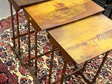 three wooden tables on a rug in a room with a chair