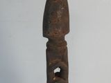 a wooden statue that is standing on a metal stand