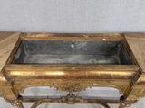 a gold table with a glass top on a white background