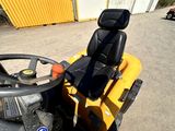 a yellow tractor with a steering and a steering wheel