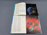 an open book with a picture of a spaceship and a spaceship on it
