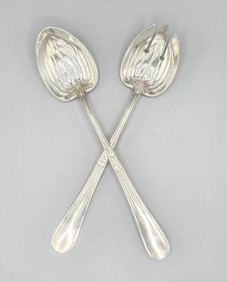 a pair of silver spoons on a grey background