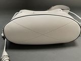 a white purse that is sitting on a table