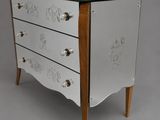 an image of a white chest of drawers on a grey background