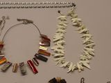 a necklace, bracelet, and other jewelry displayed on a table