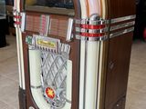 a juke box sitting on the floor in a room