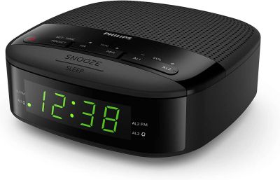 a black alarm clock sitting on top of a white surface