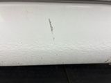 a close up of a piece of white paint on the side of a car