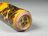 a yellow and black vase that has a black and yellow design on it
