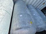 two large tanks sitting next to each other on the side of a building