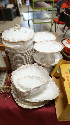 many plates and bowls sitting on a table in a room