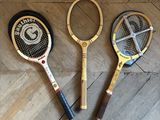 three tennis racquets on the floor next to each other