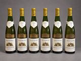 six bottles of wine are lined up in a row
