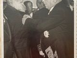 an old black and white photo of two men shaking hands