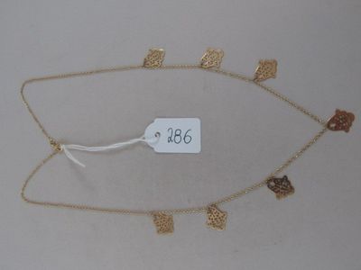 a gold necklace with a tag on it that says 366