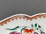 a white plate with flowers on it on a table